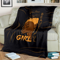 Personalized black throw blanket on couch with gold woman graphic and vertical text