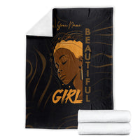 Personalized black blanket with gold woman portrait and “Your Name” beside folded whites