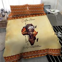 Beige bedding set with central Africa portrait print, orange and black patterned trim, shams