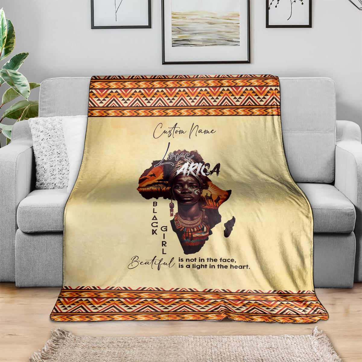 Beige throw blanket with orange geometric border and “Love Africa” portrait center graphic
