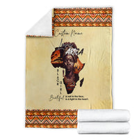 Beige blanket folded with orange/black trim, “Custom Name” and Love Africa portrait print