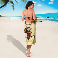Beige sarong draped on back with orange border and Africa text-and-figure graphic