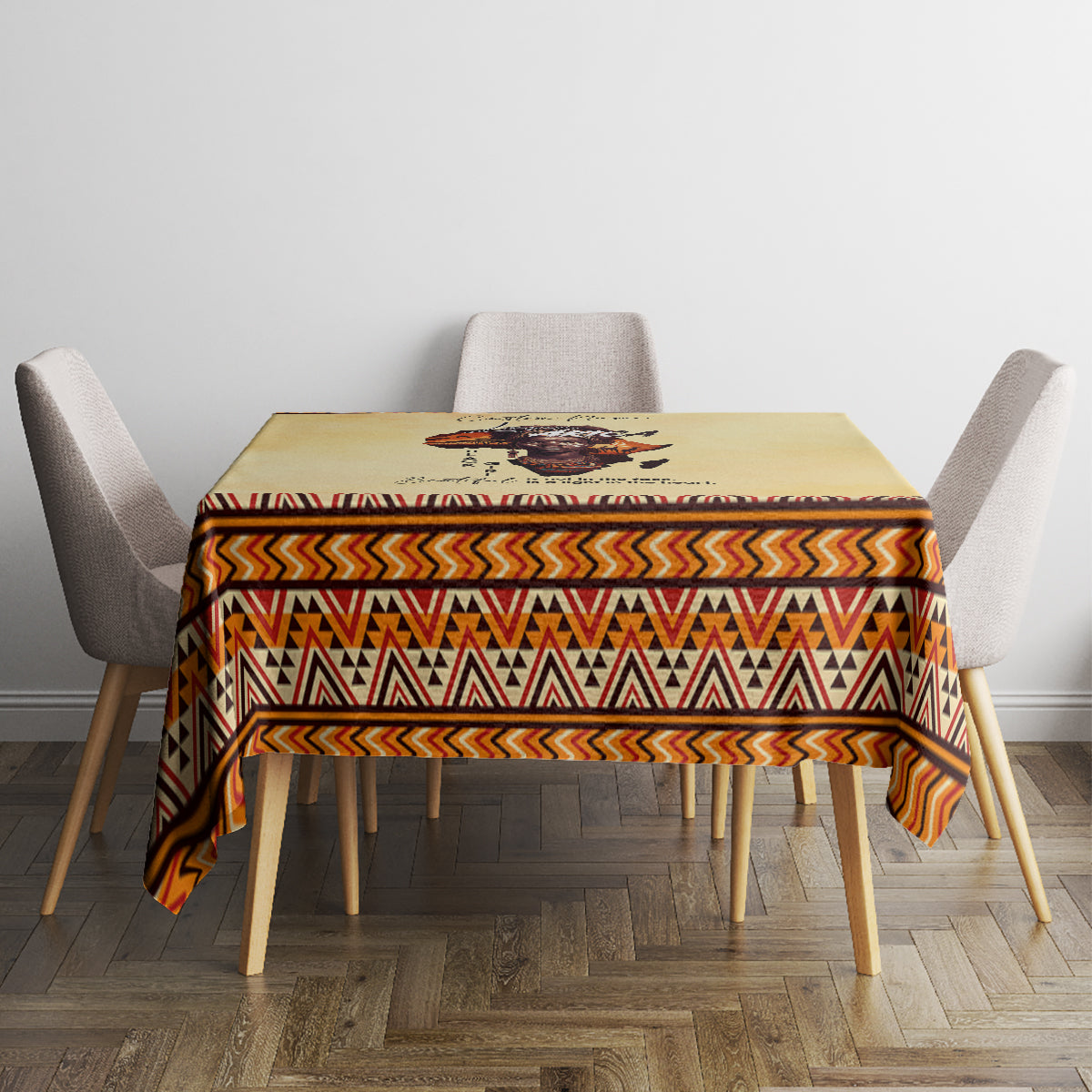 Beige tablecloth with African figure print and tribal zigzag border on dining table