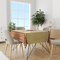 Beige tablecloth with zigzag geometric trim on rectangular dining table with chairs