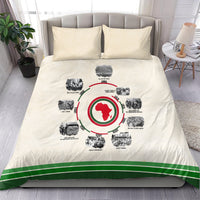Beige duvet cover with circular African timeline graphic, green stripe border and matching pillows