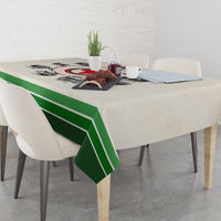 Beige tablecloth with green striped edge and central timeline print on dining table