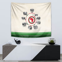 Beige tapestry with circular African map graphic surrounded by timeline images and green stripe