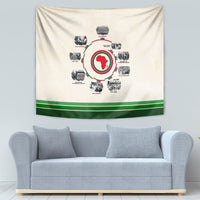 Beige tapestry with circular African medallion graphic and green bottom stripe