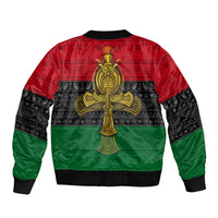 Unisex bomber jacket with gold Ankh cross on back, red/black/green patterned print