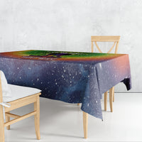 Galaxy-style tablecloth draped over table, with blue star speckles and green top