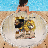 Round beige beach blanket with lion king design and fringed edge on wooden deck
