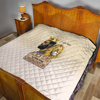 Beige quilt on bed with diamond pattern and golden lion king “Black King” print