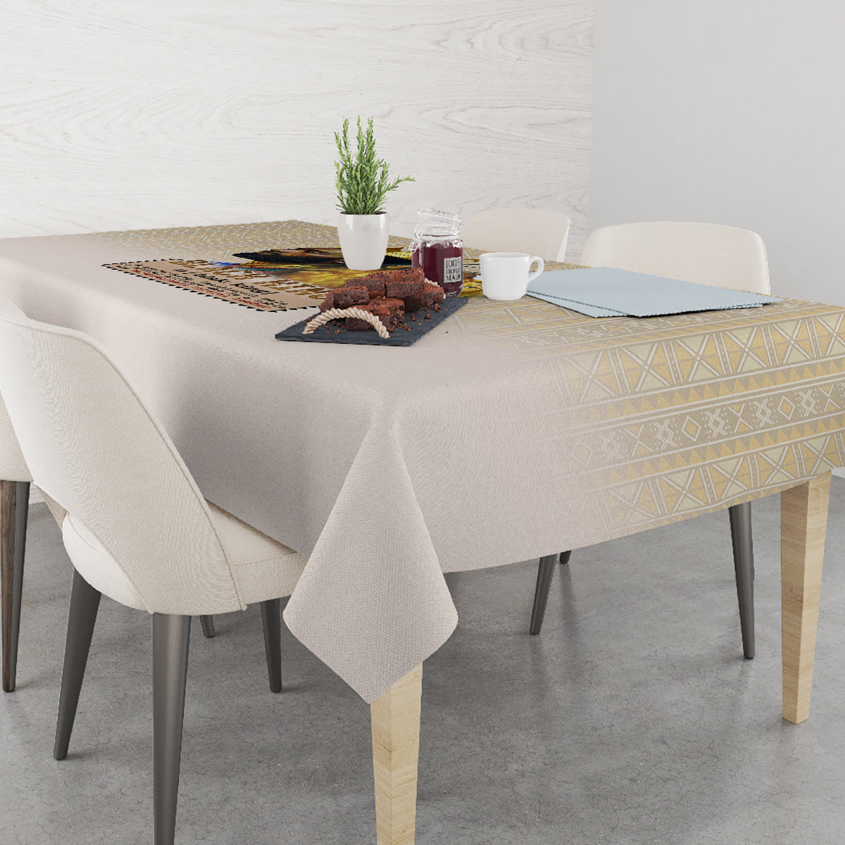 Beige rectangular tablecloth with gold geometric edge pattern and neatly draped corners