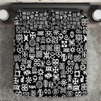 Black duvet and pillowcases featuring a white Adinkra-style symbol pattern close-up