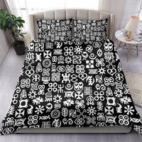 Black bedding set with white Adinkra-style symbols on duvet and two coordinating pillows