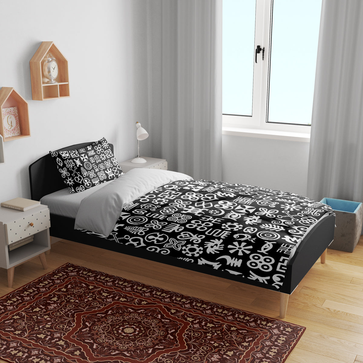 Black bedding set on bed with white Adinkra-style symbol pattern duvet and pillows