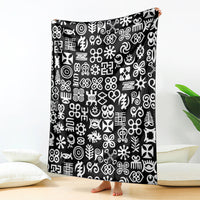 Black blanket with white Adinkra-style symbol pattern shown hanging upright