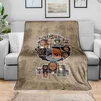 Huey Freeman taupe blanket with portrait collage on a living room sofa