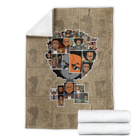Huey Freeman taupe blanket with portrait collage and neatly stacked white towels