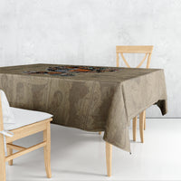 Beige tablecloth with printed African portrait motif, shown from a side angle