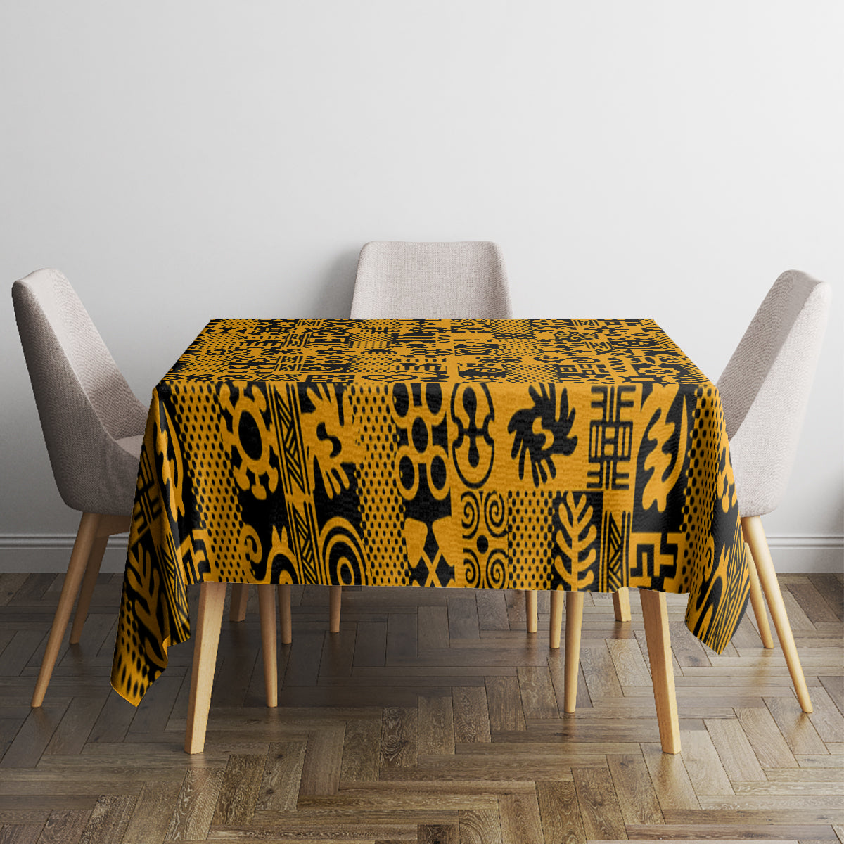Yellow tablecloth with black Adinkra symbols, covering a square table with draped sides