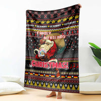 Black Christmas blanket featuring Santa holding a mug, Family & Friends text