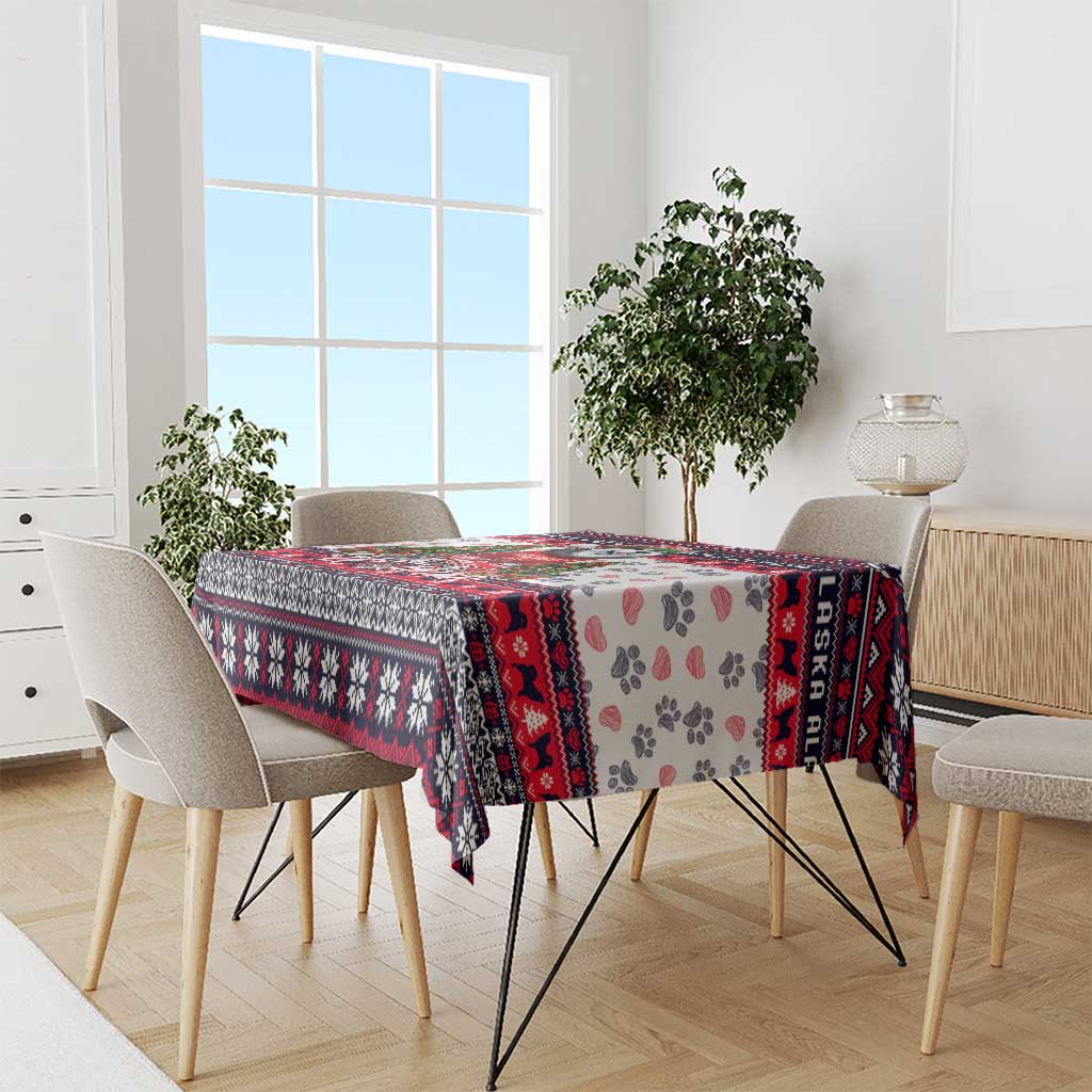 Christmas dog tablecloth in use on dining table, white with red/black border and paw prints