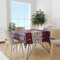 Christmas dog tablecloth in use on dining table, white with red/black border and paw prints