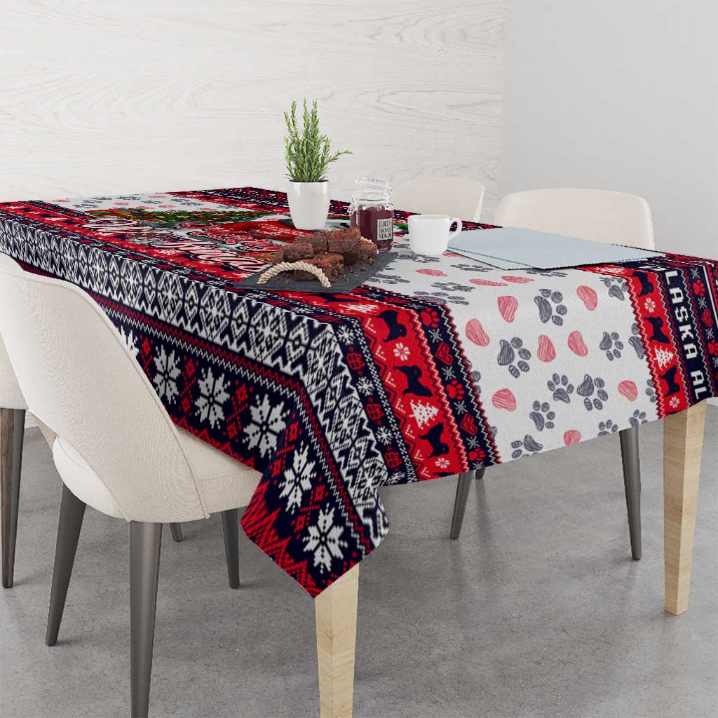 Christmas dog tablecloth corner detail, white with red/black patterns and paw print motif