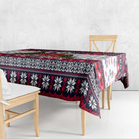 Christmas dog tablecloth draped over table, white with red/black geometric and paw print design