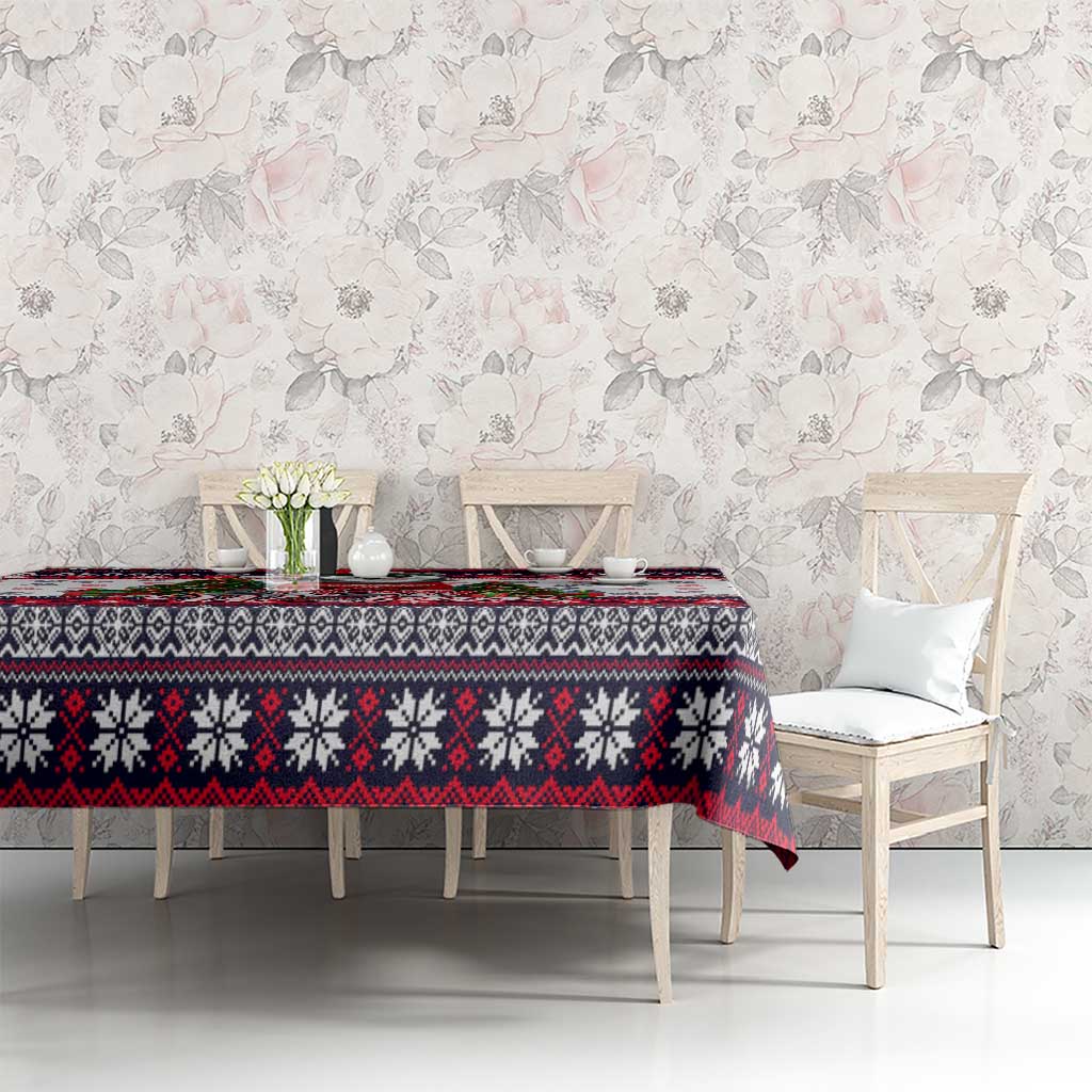 Christmas dog tablecloth on table with chair backs, white with red/black border and paw prints