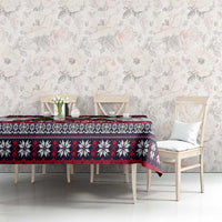 Christmas dog tablecloth on table with chair backs, white with red/black border and paw prints