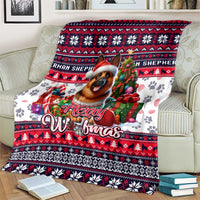 Red, navy and white dog art Christmas blanket draped on a sofa with “Merry Woofmas”