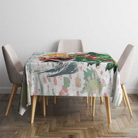 White dinosaur Christmas tablecloth on a small dining table with Merry Beermas artwork.
