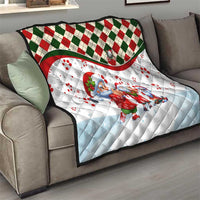 Christmas quilt on sofa with blue Santa and gnome figures, red green diamond stripe border