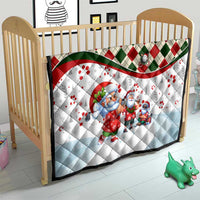 Christmas quilt blanket on wooden crib with blue Santa and gnome characters, plaid diamond edge