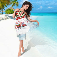 Christmas sarong wrap in white with red green argyle trim and Santa character scene