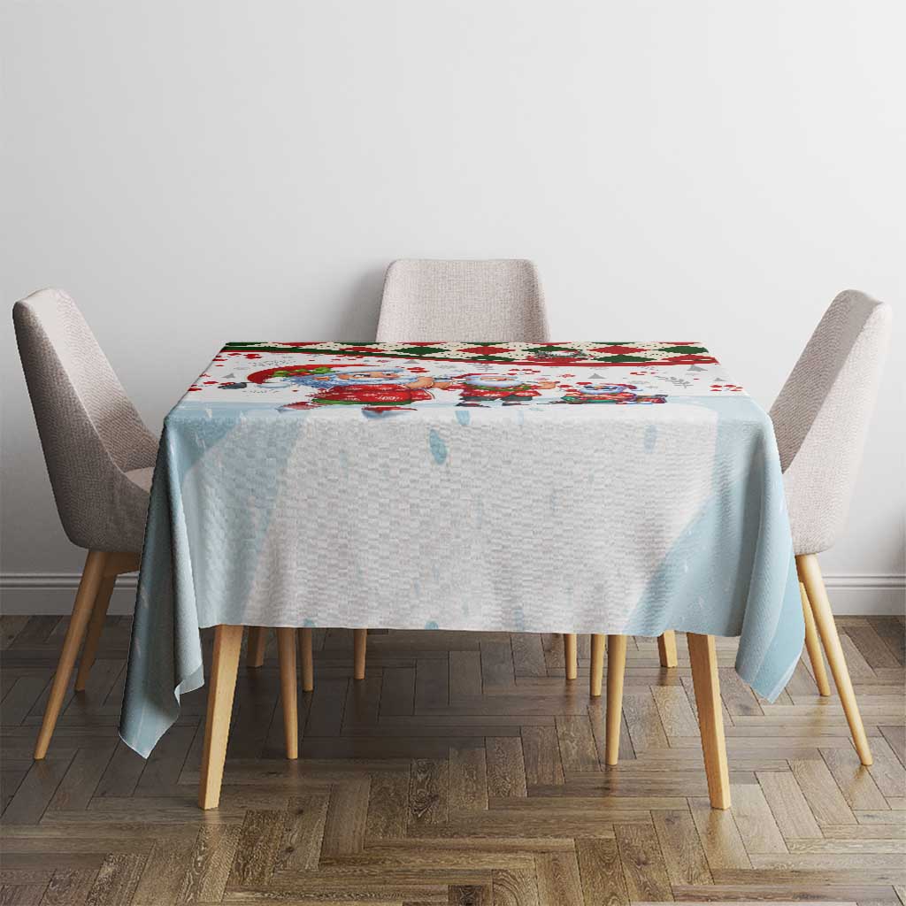 Round Christmas tablecloth on dining table, light blue base with small Santa figures