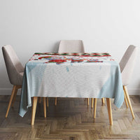 Round Christmas tablecloth on dining table, light blue base with small Santa figures