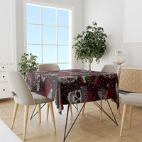 Christmas tablecloth in red and black with skulls and green pepper motifs on dining table