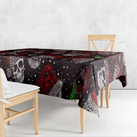 Rectangular Christmas tablecloth with black skull faces, red accents, and green chili design