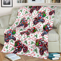White Santa motorbike Christmas blanket spread out, with colorful border pattern