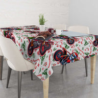Christmas tablecloth over dining table: white base with red, green, blue motorbike Santa motif
