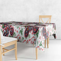 Christmas tablecloth with white base and bold red blue motorbike Santa print, corner drop