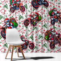 Close view of white curtain fabric with Santa motorbike print, red green details.