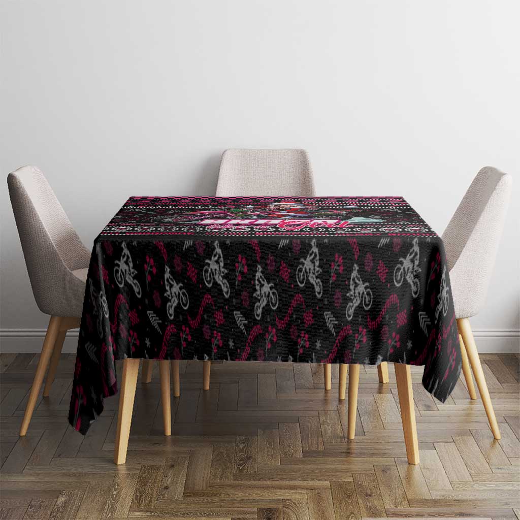 Black printed Christmas tablecloth with pink and red border pattern on dining table.