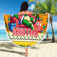 Round yellow Christmas beach blanket featuring cartoon crocodile in Santa suit and fringe