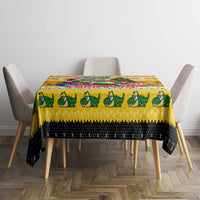 Yellow Christmas tablecloth with crocodile row design and black bottom trim