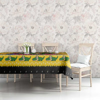 Yellow Christmas tablecloth on dining table with crocodile pattern and black edge