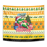Yellow Christmas tapestry close-up of cartoon alligator beside a decorated tree and 'CHRISTMA'